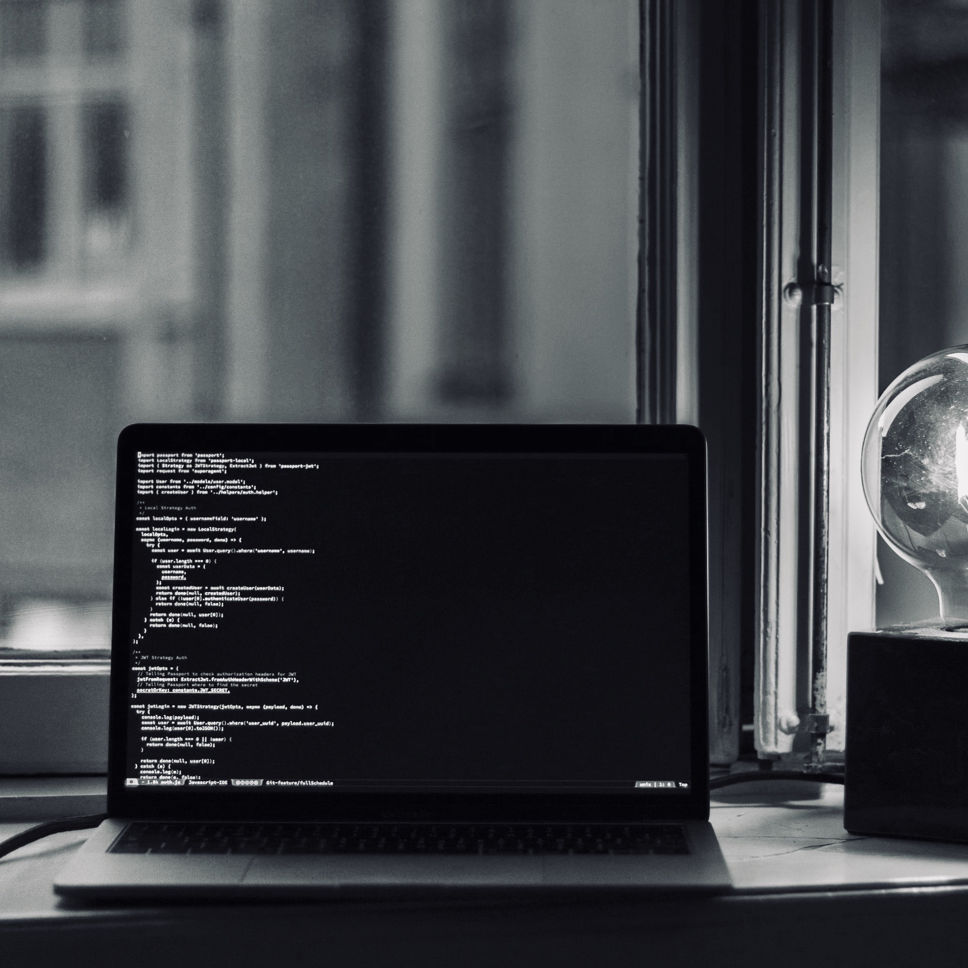 Computer with code on the screen at night time